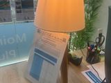 a desk with a lamp and a phone on it