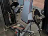 a gym room with a bench, weights, and other equipment