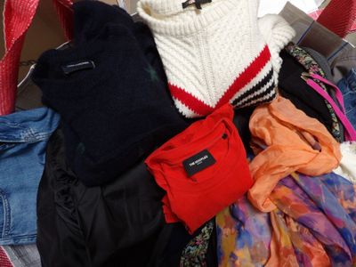 a pile of clothes that is sitting in a suitcase