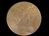 an image of a close up of a gold medal on a black background