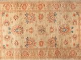 an antique rug with a floral design on a beige ground