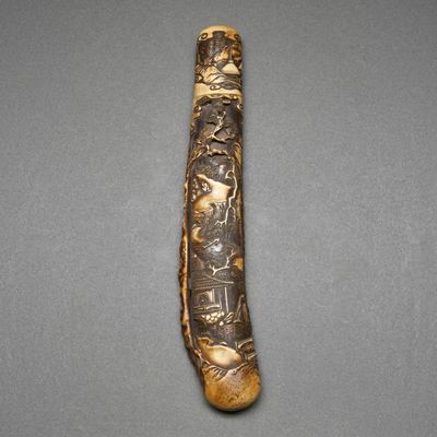 a close up of a wooden stick with carvings on it