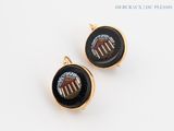 pair of black and gold earrings with an american flag on them