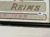 a sign that says reims on the side of a building