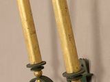 two candles that are on the wall next to each other