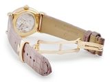 an image of a wrist watch with a gold case and brown leather strap