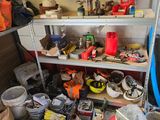 a garage with a lot of clutter and tools on the shelves