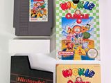 three nintendo games on a table with a book