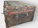 an old trunk that is sitting on the ground