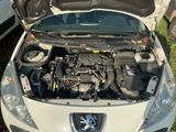 a car with its hood open and the engine in the back