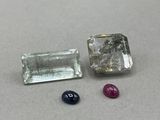 two different colored gems sitting next to each other on a table