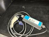a cable connected to a device in the trunk of a car