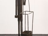 sculpture of a man with a bucket and a bucket on a stand