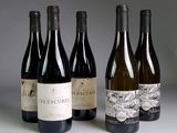 several bottles of wine are lined up on a table