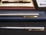 a pen that is sitting on a desk next to other pens