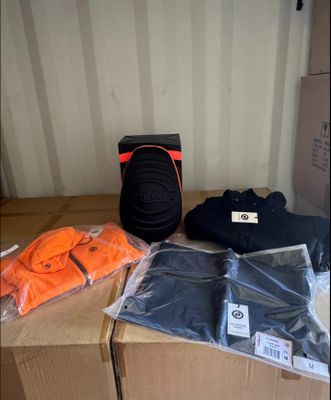 a box with a backpack, a pair of shoes, a pair of pants, and a pair of socks