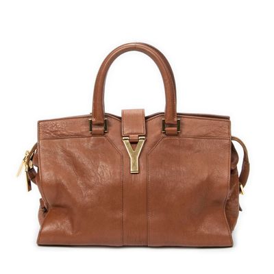 a close up of a brown handbag on a white background