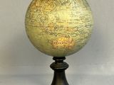 an old globe on a stand with a white background