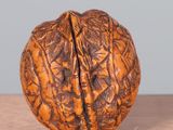 a walnut that has been carved into the shape of a human head