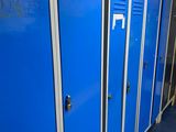 several blue lockers are lined up in a row in a hallway