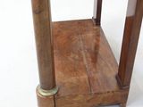 a small wooden table with a glass top on a white floor