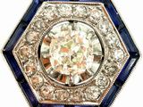 an image of a diamond and sapphire broochle on a white background