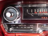 a red car dashboard with an old fashioned radio on it