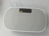 a white speaker that is sitting on a table