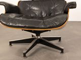 a black leather chair with a wooden base and a black leather seat
