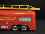 a red toy fire truck with a ladder on top of it