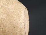a stone object that is sitting on a black surface