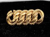 an image of a close up of a gold bracelet on a black surface