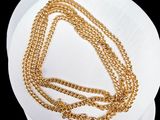 gold plated chain necklace with a clasp on a white hat