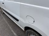 a white van that is parked on the side of the road