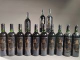 several bottles of wine are lined up on a white surface