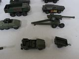 many toy army vehicles and trucks on a table