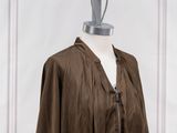 the dress is brown and has a zippered neck and long sleeves
