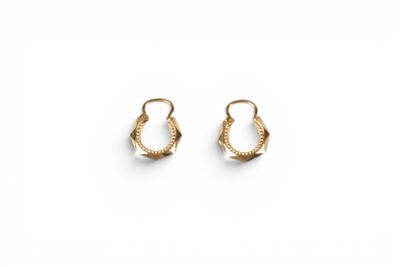 a pair of gold hoop earrings on a white background