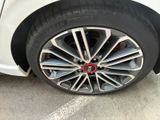 a close up of a tire on a car in a parking lot