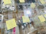 many plastic containers filled with assorted items on a table