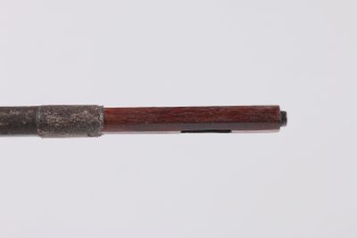 a close up of a pen with a wooden handle on a white surface