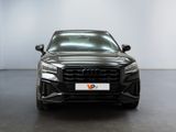the front of a black audi qx parked in a white room