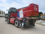 a red crane that is sitting on the back of a truck
