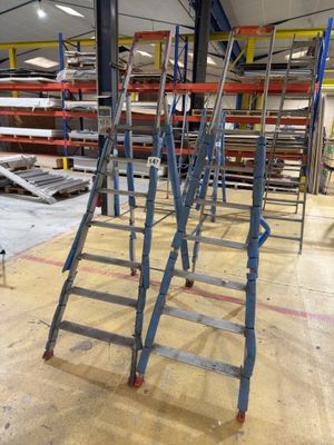 many ladders that are sitting in a warehouse