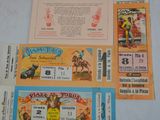 several tickets for a rodeo show are on a table