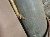 a metal pipe that has a yellow handle on it