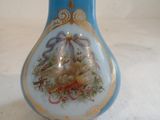 a blue vase with a picture on it sitting on a table