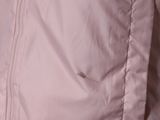 a close up of a pink jacket with a button on it