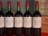 four bottles of wine are lined up on a table