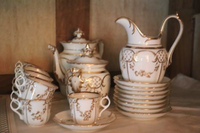 a lot of cups and saucers on a table